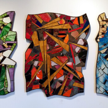 Three abstract mosaic panels in green, purple, orange, red, blue, and brown tiles mounted on a white wall.