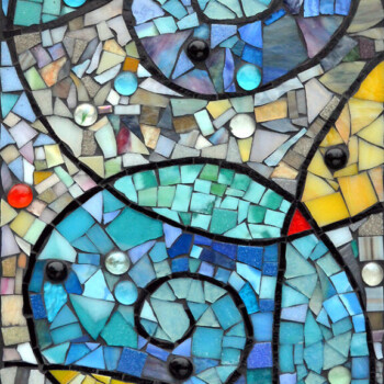 Colorful mosaic featuring two large blue spirals and scattered glass beads on a background of varied geometric tiles.