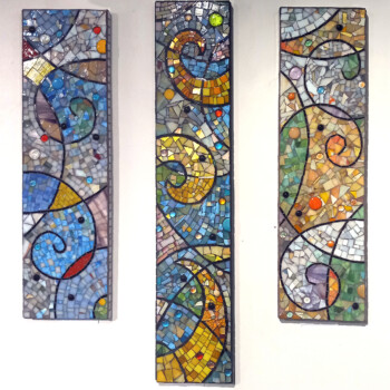 Three colorful abstract mosaic panels with swirling patterns and geometric shapes arranged vertically on a white wall.