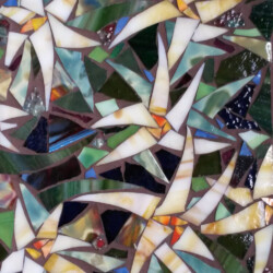Mosaic artwork featuring star-shaped white flowers with green leaves, created from stained glass pieces.