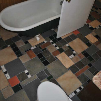 SOLD Bathroom with a clawfoot tub, patterned tile floor, partially open door, toilet, and marble countertop.