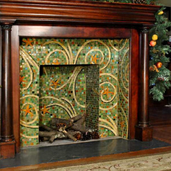 SOLD Dark wood fireplace with green and gold mosaic tile, decorated with garland and festive ornaments on each side.