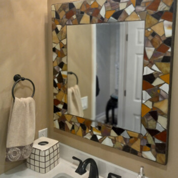 A mirror above a sink.