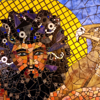 Mosaic artwork depicting a stylized person with an eagle, set against a yellow circular background.