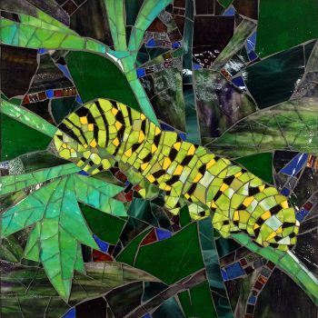 SOLD Mosaic artwork depicting a yellow and black caterpillar on green leaves with a colorful, stained-glass style background.