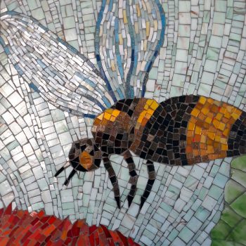 SOLD Mosaic artwork of a bee with black and yellow stripes hovering above a red flower.