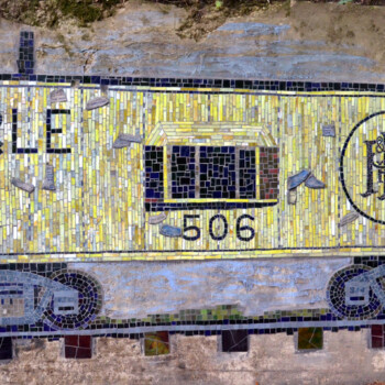 Mosaic mural of a yellow P&LE train boxcar with number 506 and scattered white feathers on a concrete wall.