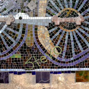Mosaic artwork depicting two large bicycle wheels and a chain against a tiled background.
