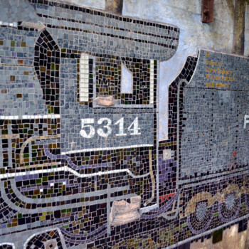Mosaic mural of a train locomotive with the number 5314 and partial word "Pittsburg" on a concrete wall.